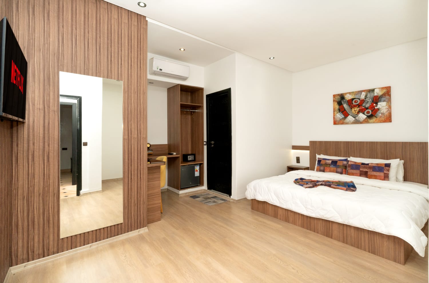 Double room with wood-panel wall and flat-screen TV
