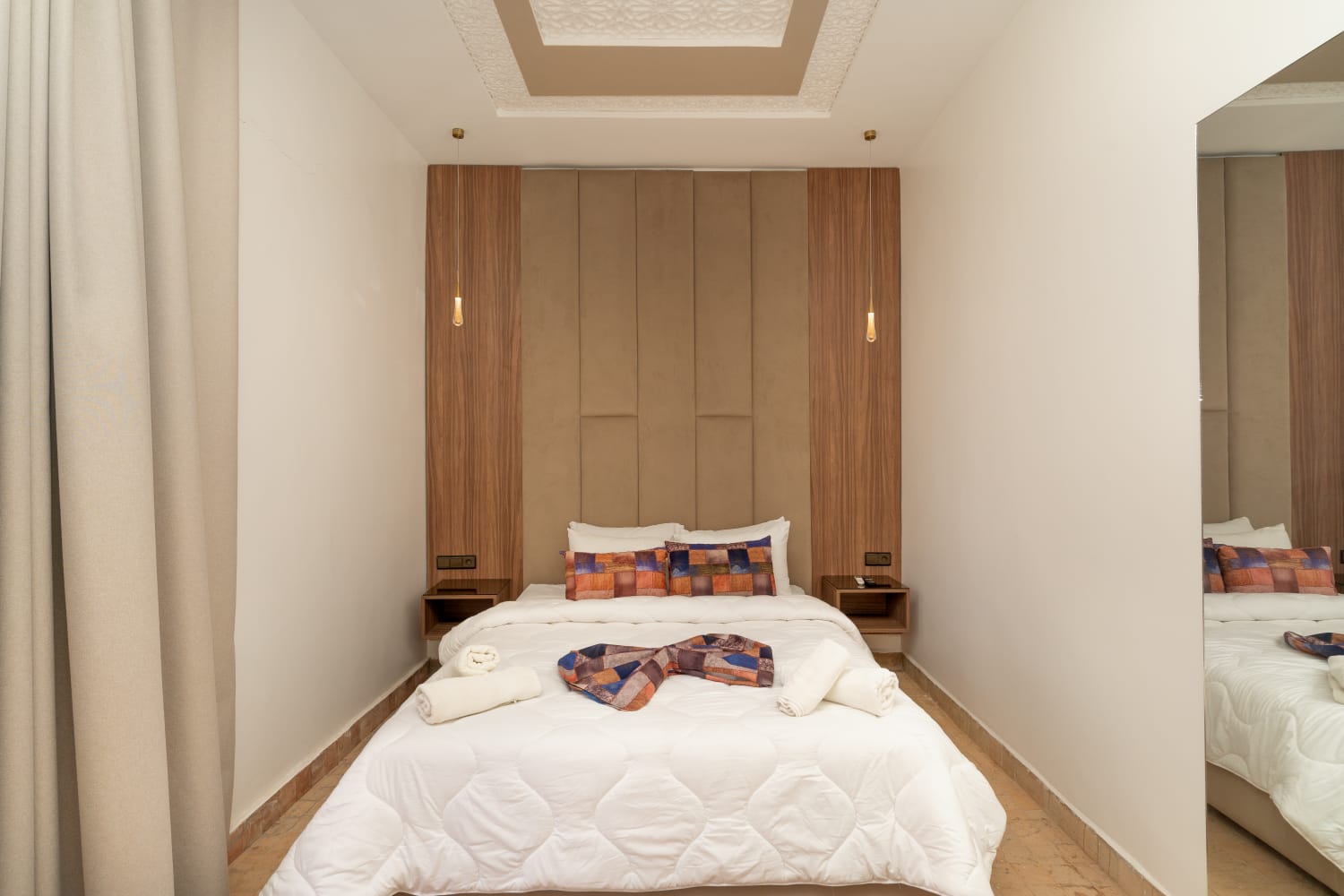 Double bed with wood and velvet headboard detailing