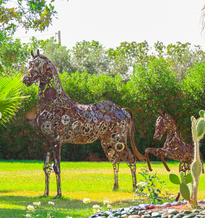 Metal horse sculptures on the lawns of Jnane Riad