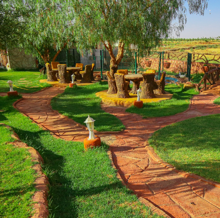 Landscaped garden with lawns and traditional seating at Jnane Riad