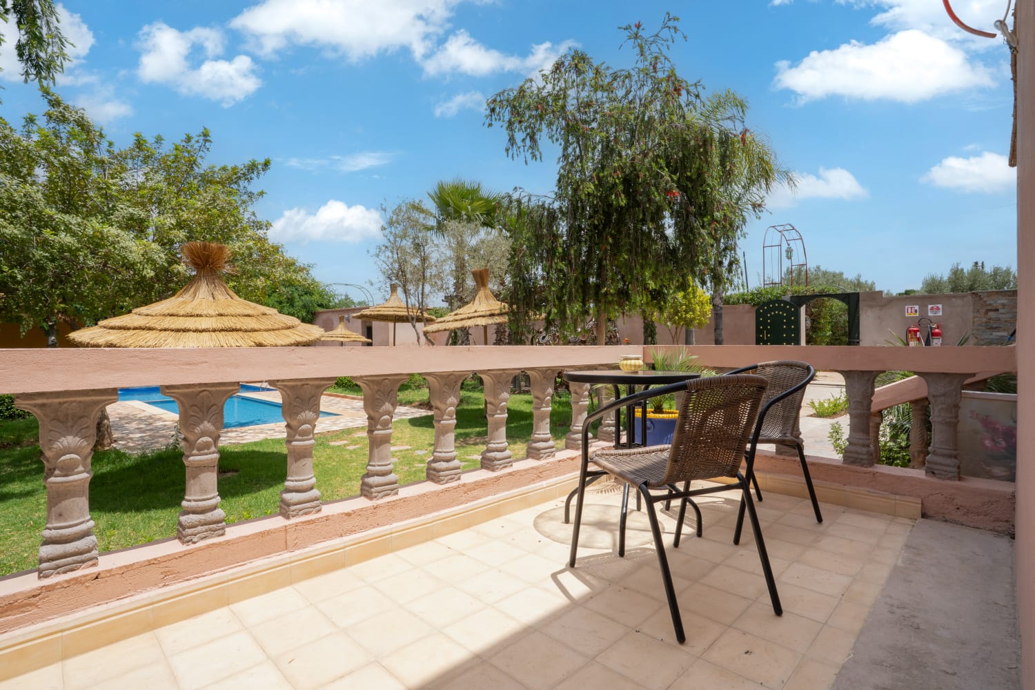 Terrace overlooking the pool and gardens as the day cools at Jnane Riad