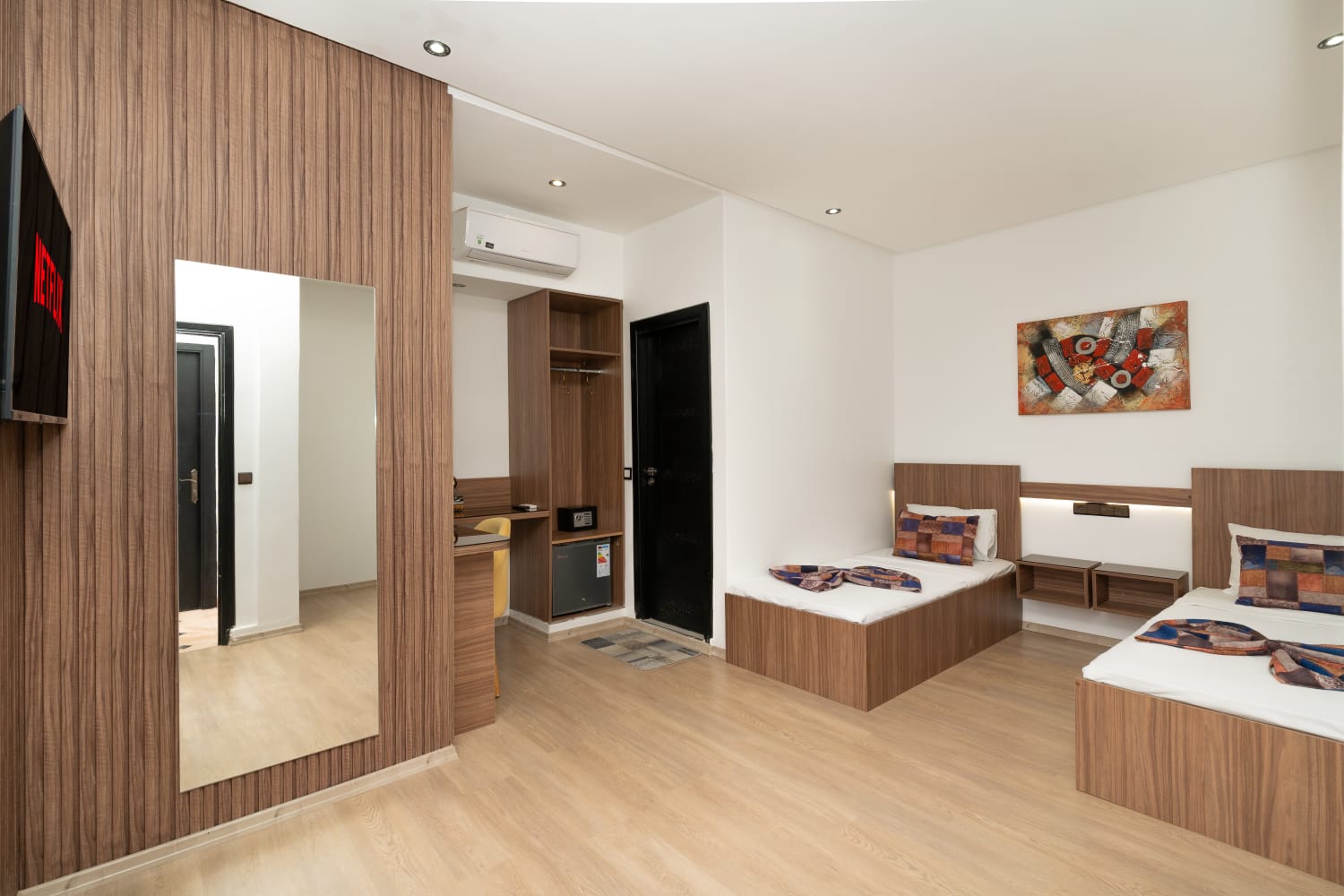 Twin room with two single beds and wood detailing at Jnane Riad