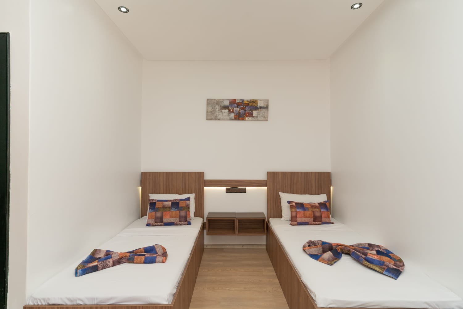 Bright twin room with two neatly made single beds